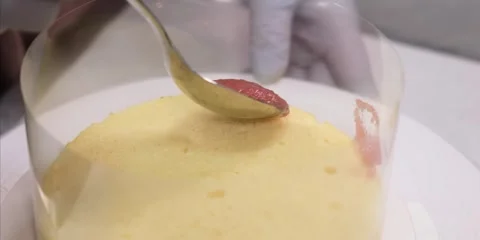 Baking Chef Spreading Pink Cream on Sponge Cake Layer Stock Footage 343589138