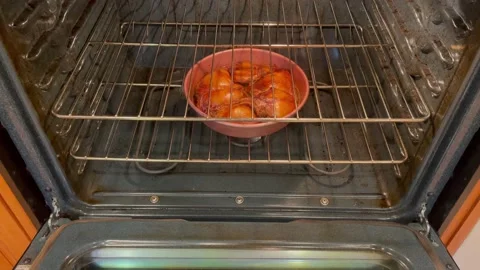 Baking chicken in oven for dinner Stock Footage 145032772