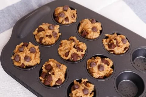 Baking chocolate chip muffin with baking pan Stock Photos