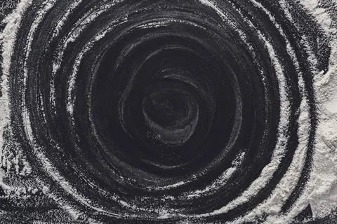 Baking concept on black background, sprinkled flour with copy space Stock Photos