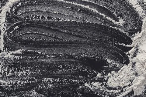Baking concept on black background, sprinkled flour with copy space Stock Photos