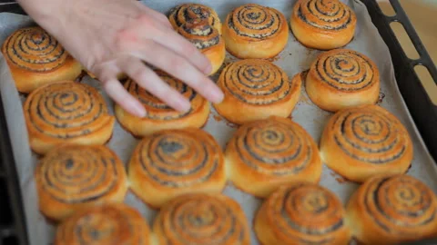Baking concept. Chef hands show hot fresh roll buns with poppy in the bakery. Video stock 101139700