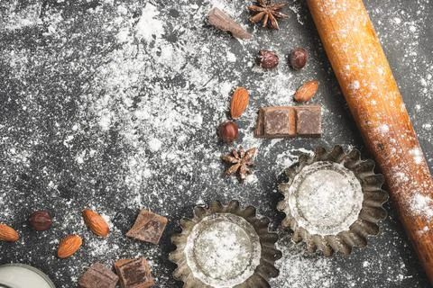 Baking concept, cupcake form and food ingredients on a dark background, prepa Stock Photos