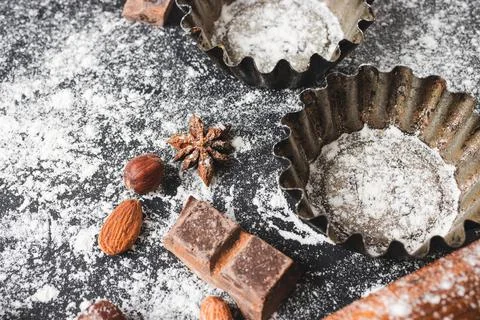 Baking concept, cupcake form and food ingredients on a dark background, prepa Stock Photos