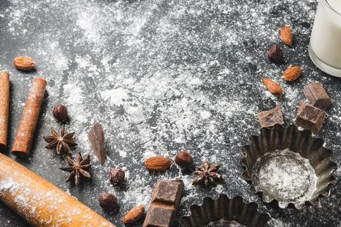 Baking concept, cupcake form and food ingredients on a dark background, prepa Stock Photos