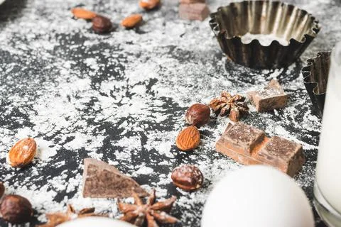Baking concept, cupcake form and food ingredients on a dark background, prepa Stock Photos