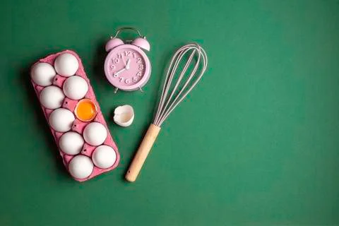 Baking concept flat lay with eggs, clock and whisk Stock Photos