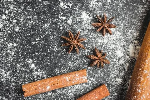 Baking concept, rolling pin, star anise and cinnamon stick on a dark backgrou Stock Photos