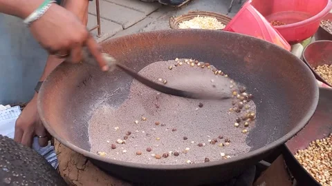 Baking Corn in Sand Stock Footage 161723622