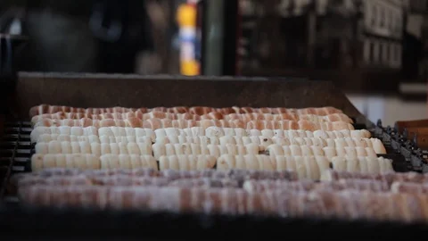 Baking Czech trdelnik on a rotating spits in Prague Stock Footage 88224412