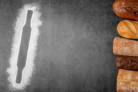Baking dark background with copy space with bread and outline of rolling pin Stock Photos