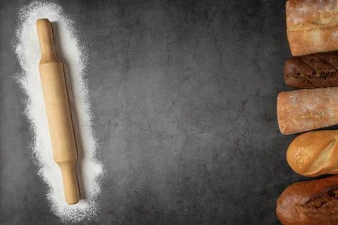 Baking dark background with copy space with fresh bread and rolling pin Stock Photos