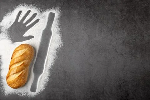 Baking dark background with fresh whole loaf of bread and outlines of ingre.. Foto stock