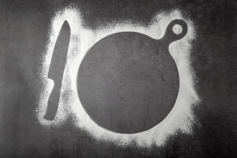 Baking dark background with the outlines of ingredient flour a cutting board  Stock Photos