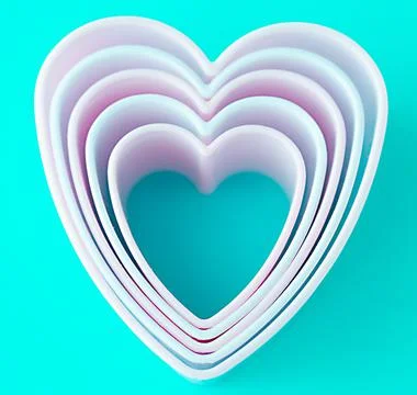Baking dish in the form of hearts on a blue background, concept photo, symbol Stock Photos