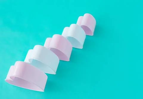 Baking dish in the form of hearts on a blue background, concept photo, symbol Stock Photos