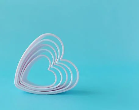 Baking dish in the form of hearts on a blue background, concept photo, symbol Stock Photos