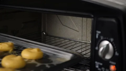 Baking dough in small oven at home, 4K Stock Footage 128412504