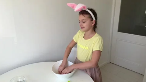 Baking Easter gingerbread cookies. little happy girl bakes cookies for easter Stock Footage 268705186