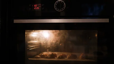 Baking Eclair in Oven Tray. Made of Choux Dough filled with Vanilla cream. Close Stock-Footage 129306274
