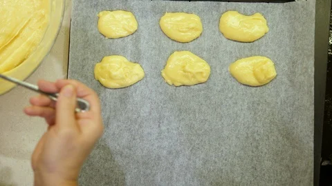 Baking Eclair. Women hand adding on Tray. Made of Choux Dough filled Vanilla. Stock-Footage 129306019