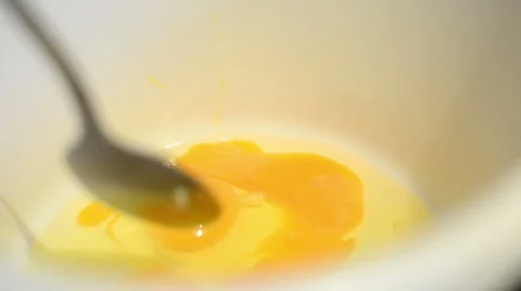 Baking with eggs searching with spoon for shell parts in bowl Video stock 44242447