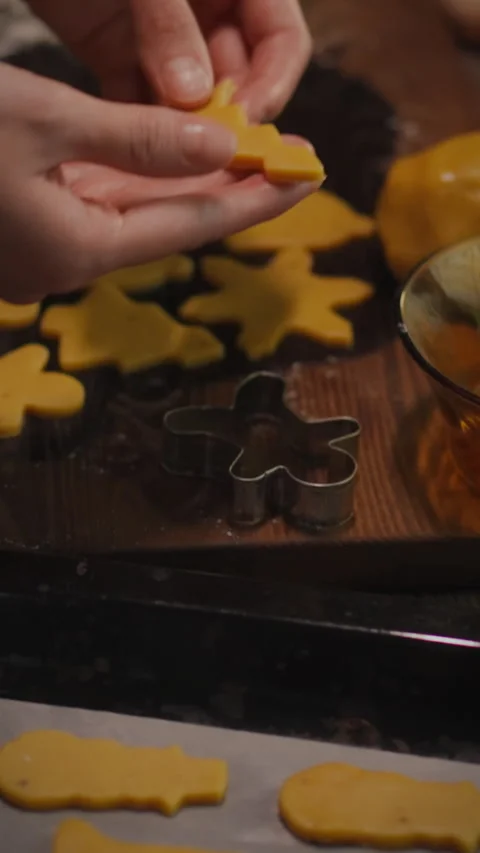 Baking festive cookies with a gingerbread cutter in a cozy kitchen setting Stock Footage 331535561