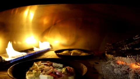 Baking in a fire stove onven Stock Footage 83551473