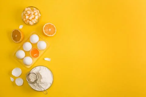 Baking flat lay background with eggs floor butter lemon sieve Stock Photos