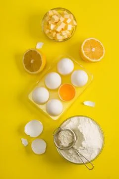 Baking flat lay background with eggs floor butter lemon sieve Stock Photos