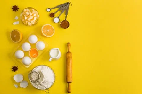 Baking flat lay background with eggs floor butter lemon sieve Stock Photos