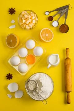 Baking flat lay background with eggs floor butter lemon sieve Stock Photos