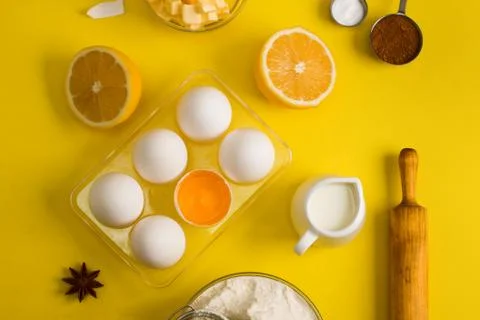 Baking flat lay background with eggs floor butter lemon sieve Stock Photos
