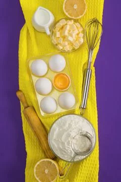 Baking flat lay composition with eggs floor butter lemon milk Stock Photos