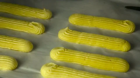 Baking French traditional Eclairs or Profiterole in a professional oven Video stock 62804213