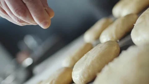 Baking Fresh Burger Buns Being Topped with Sesame in a Professional Kitchen 库存影片 331100948