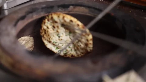 Baking Fresh Naan Bread in Traditional Clay Tandoor Oven Video stock 346009449