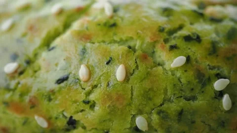 Baking a green bread with sesame seeds in a kitchen Stock Footage 340814747