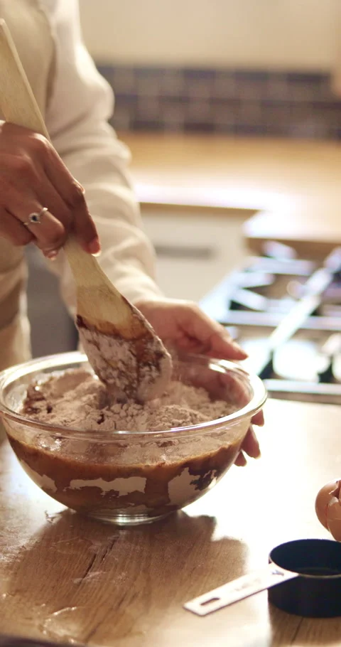 Baking, hands and mixing ingredients in home for cake batter, recipe process and Stock Footage 342882712