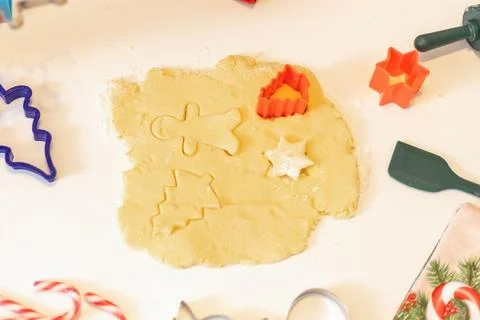 Baking holiday cookies using cookie cutters in a cozy kitchen setting durin.. Stock Photos