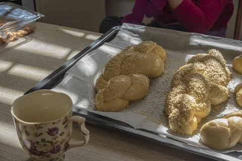Baking homemade challah bread. A braid with sesame seeds in a pan before baking Stock Photos