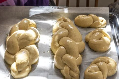 Baking homemade challah bread. A braid with sesame seeds in a pan before baking Stock Photos
