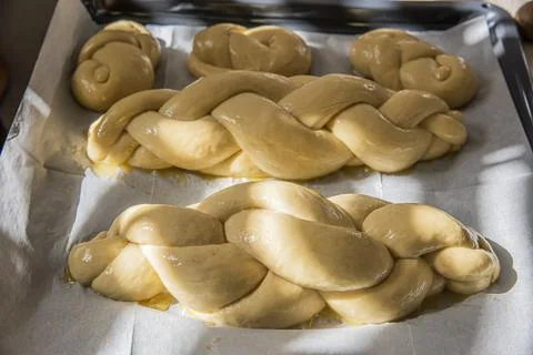Baking homemade challah bread. A braid with sesame seeds in a pan before baking Stock Photos