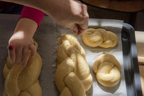 Baking homemade challah bread. A braid with sesame seeds in a pan before baking Stock Photos