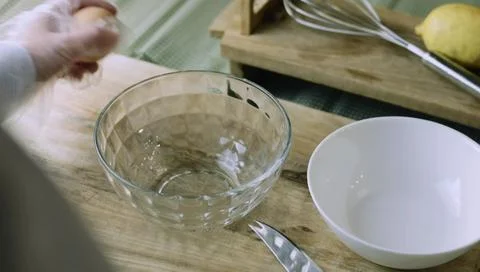 Baking Ingredient Setup with Eggs Bowls and a Metal Whisk Stock Photos