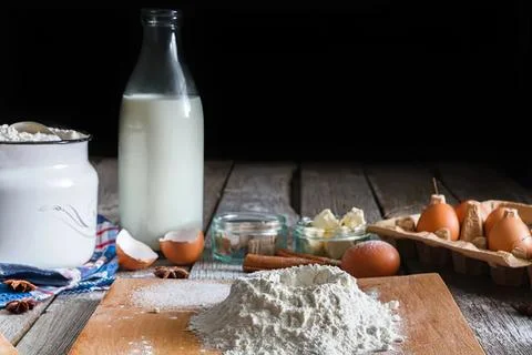 Baking ingredients and dough on rustic wooden table Stock Photos