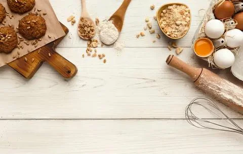 Baking ingredients and eggs on a white wooden table Stock Photos