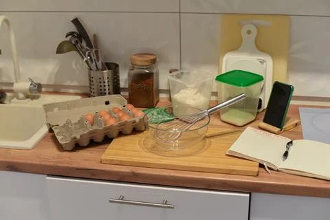 Baking ingredients and tools on kitchen counter with modern kitchen background Foto stock