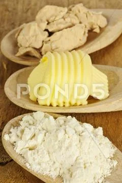 Baking ingredients butter, yeast and meal Stock Photos