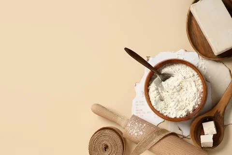 Baking ingredients flat lay with flour, yeast, rolling pin, and recipe on bei Stock Photos